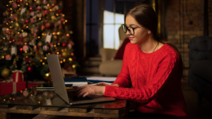 Women typing with xmas tree